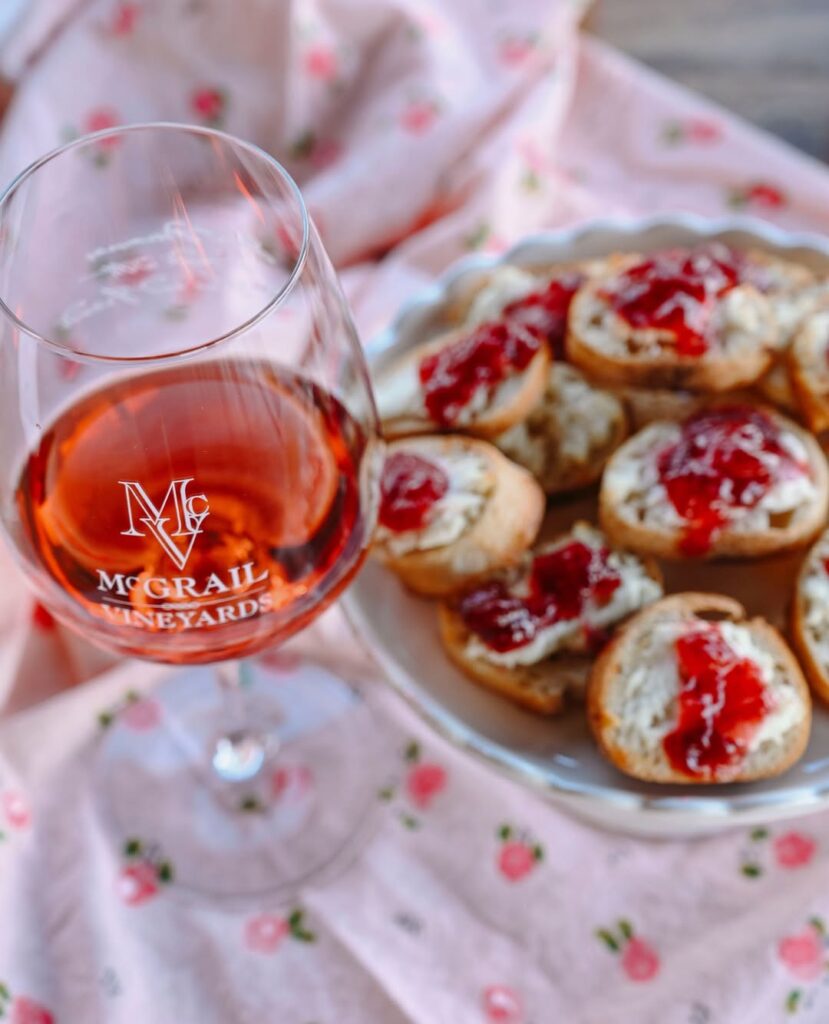 Glass of rosé wine served with crostinis on a plate at McGrail Vineyards.