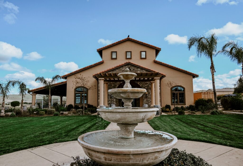 Fountain in front of the McGrail Vineyards tasting room under a blue sky.