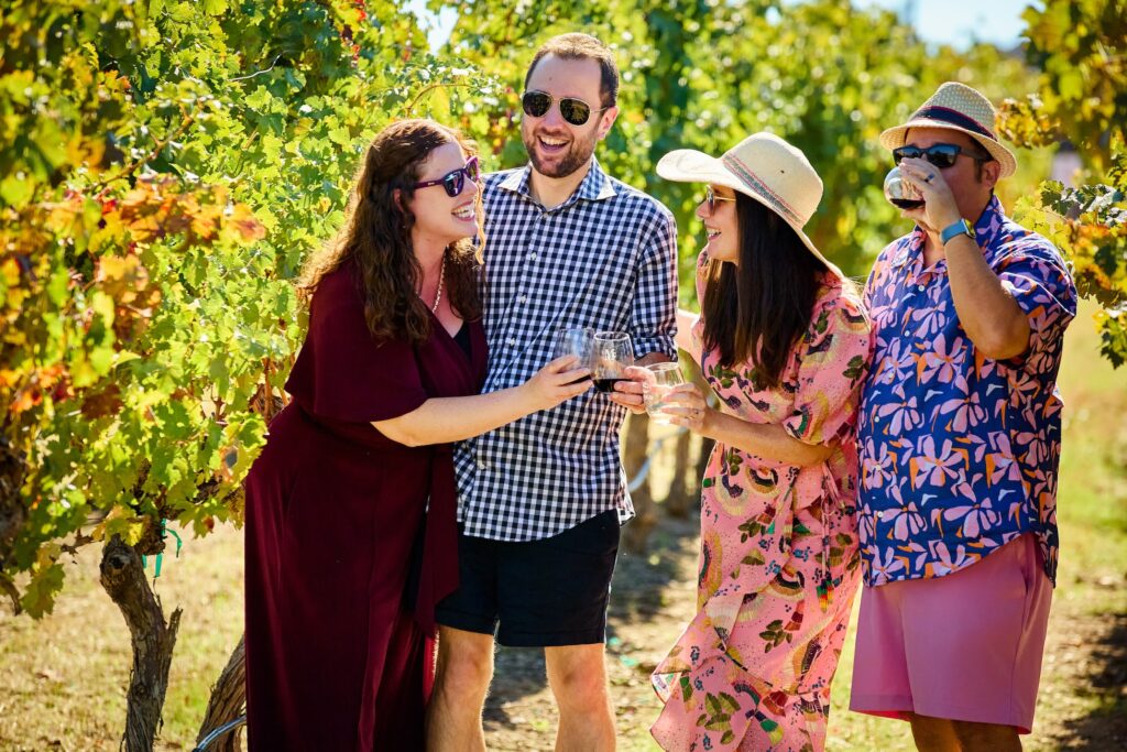 Guests enjoying wine tasting at McGrail Vineyards with estate vineyards stretching across the Livermore Valley landscape.